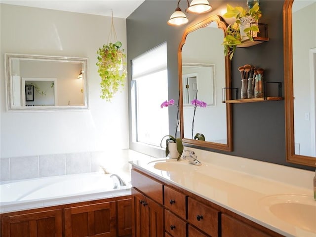 full bath with a bath, a sink, and double vanity