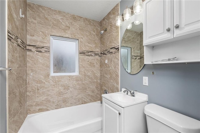 bathroom featuring vanity, shower / bathing tub combination, and toilet