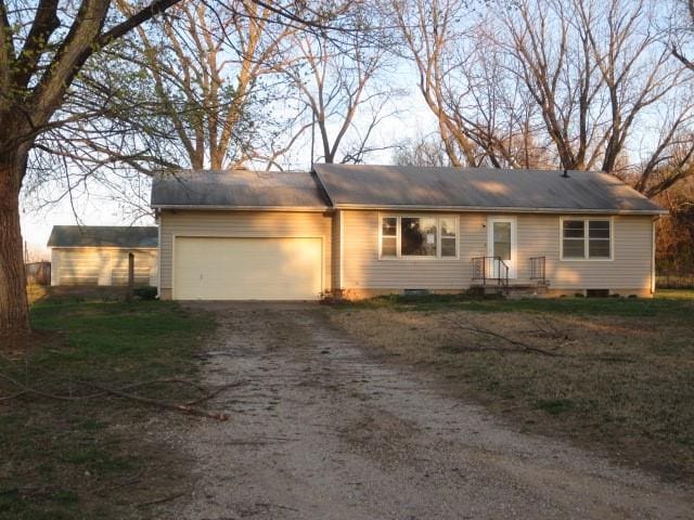 ranch-style house with an attached garage and driveway