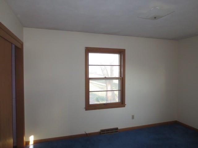 spare room featuring visible vents and baseboards