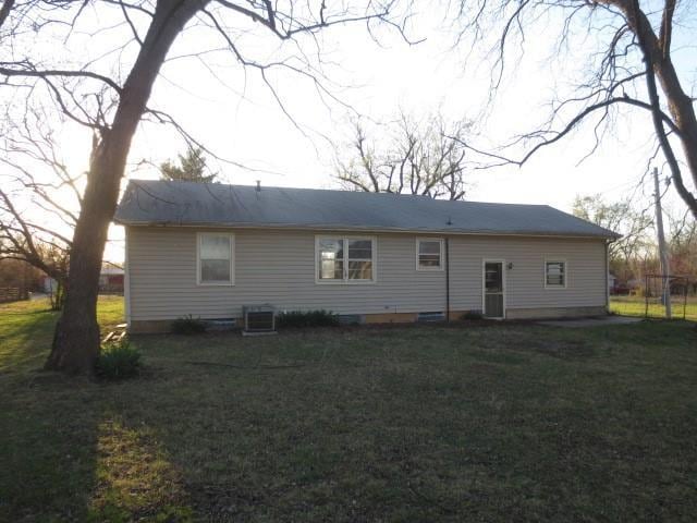 back of property with a lawn