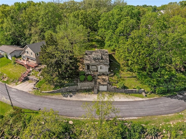 view of subject property with a heavily wooded area
