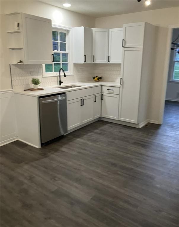 kitchen featuring light countertops, white cabinets, a sink, and dishwasher