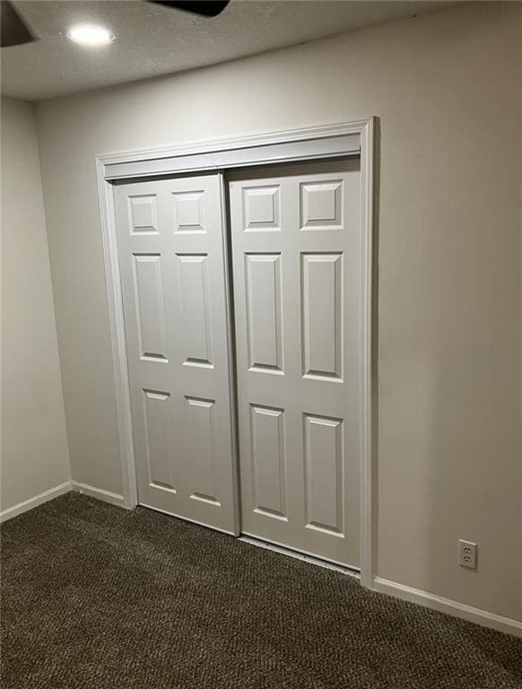 interior details featuring baseboards and carpet