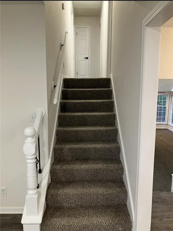 stairway featuring baseboards and wood finished floors