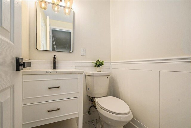 11715 E 60th St, Kansas City, MO 64133 - half bath with vanity, toilet, and wainscoting
