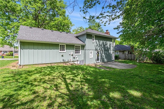 11715 E 60th St, Kansas City, MO 64133 - rear view of property with a yard, roof with shingles, fence, and a patio