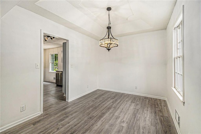 11715 E 60th St, Kansas City, MO 64133 - unfurnished dining area featuring baseboards, dark wood-style flooring, a notable chandelier, and visible vents