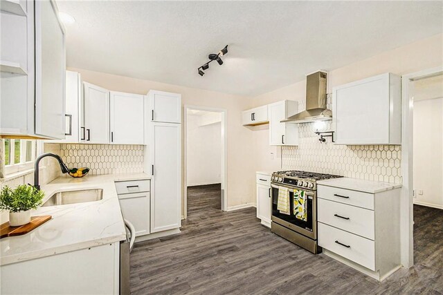 11715 E 60th St, Kansas City, MO 64133 - kitchen featuring stainless steel range with gas cooktop, a sink, white cabinets, and wall chimney exhaust hood