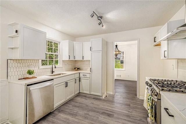 11715 E 60th St, Kansas City, MO 64133 - kitchen with a sink, open shelves, stainless steel appliances, light countertops, and decorative backsplash