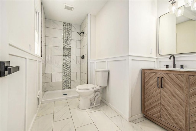 11715 E 60th St, Kansas City, MO 64133 - bathroom with toilet, marble finish floor, vanity, visible vents, and a tile shower