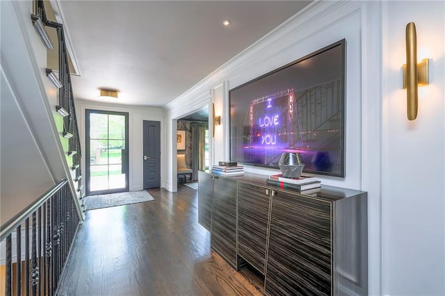 foyer featuring ornamental molding and dark wood-style floors