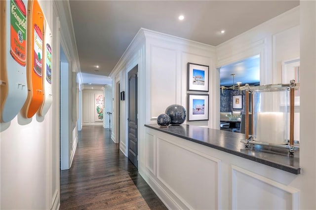 hall featuring recessed lighting, ornamental molding, dark wood finished floors, and baseboards