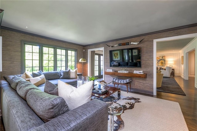 living room with crown molding, wallpapered walls, and wood finished floors