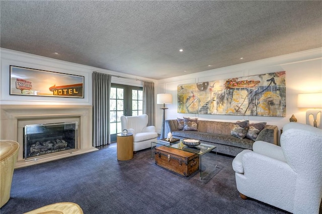 living area featuring a glass covered fireplace, carpet floors, and a textured ceiling