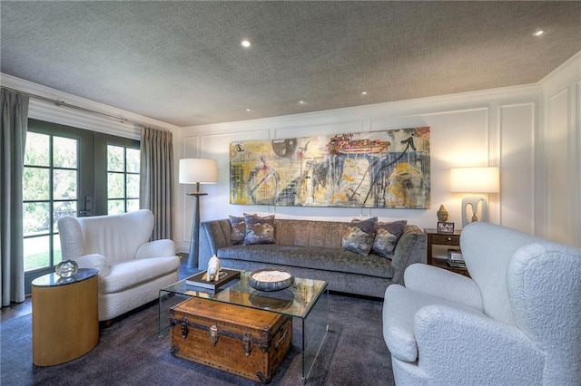 carpeted living area with french doors, recessed lighting, a textured ceiling, and a decorative wall
