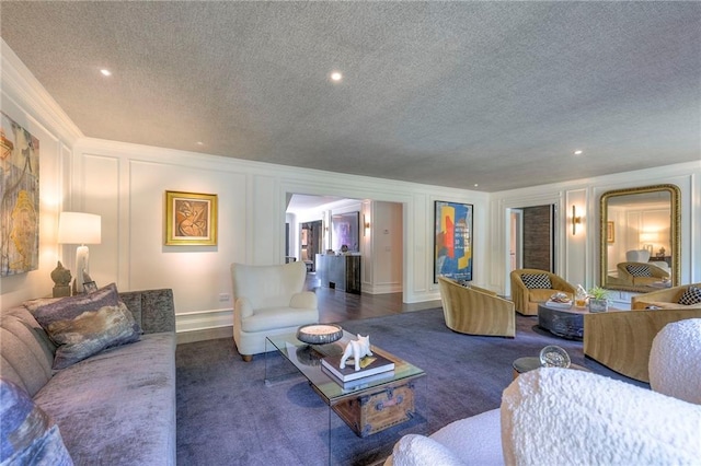carpeted living area featuring recessed lighting, a textured ceiling, and a decorative wall