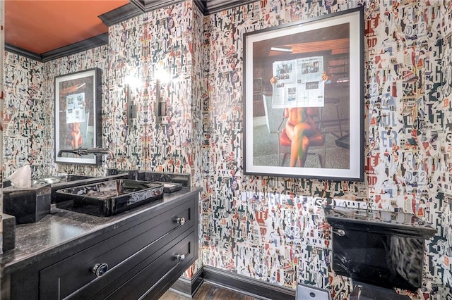 bathroom featuring wallpapered walls and wood finished floors