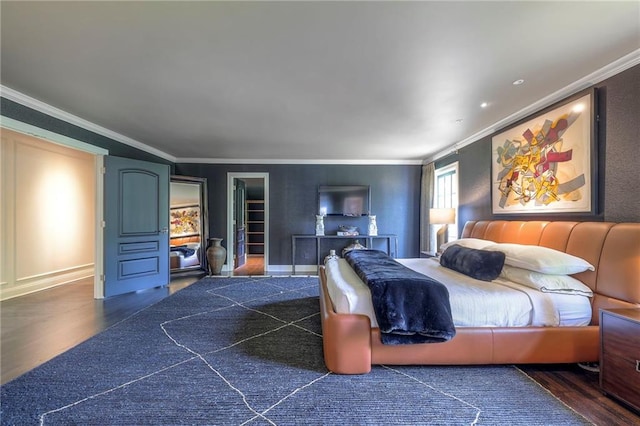 bedroom with crown molding, baseboards, and wood finished floors
