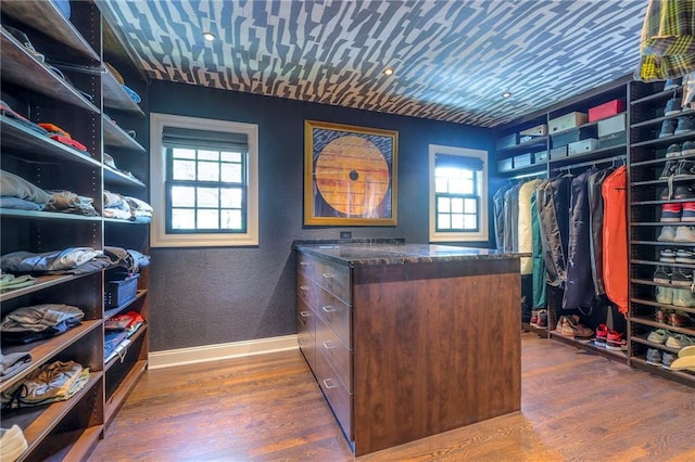 spacious closet with dark wood-style flooring