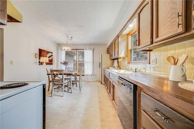 kitchen with a sink, a chandelier, brown cabinetry, stainless steel dishwasher, and decorative backsplash