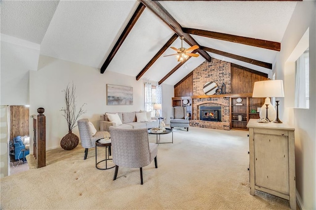 living room featuring lofted ceiling with beams, a textured ceiling, a ceiling fan, carpet flooring, and a brick fireplace