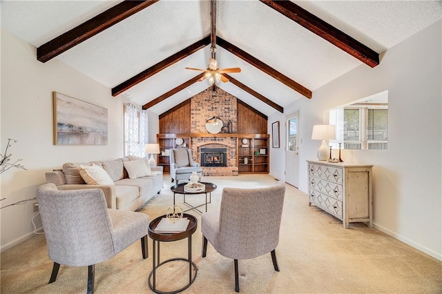 living area with ceiling fan, lofted ceiling with beams, light carpet, a brick fireplace, and baseboards