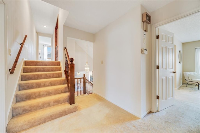 stairway with carpet and baseboards