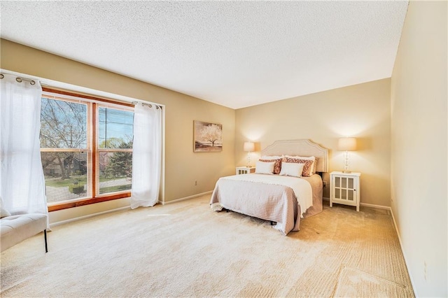 bedroom with carpet floors, baseboards, and a textured ceiling