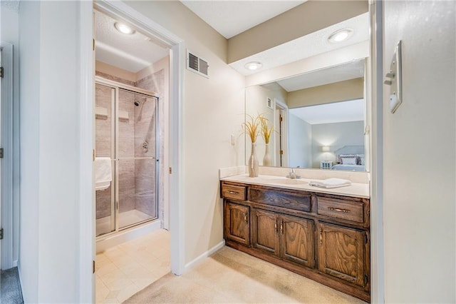 full bathroom with visible vents, baseboards, a shower stall, and vanity