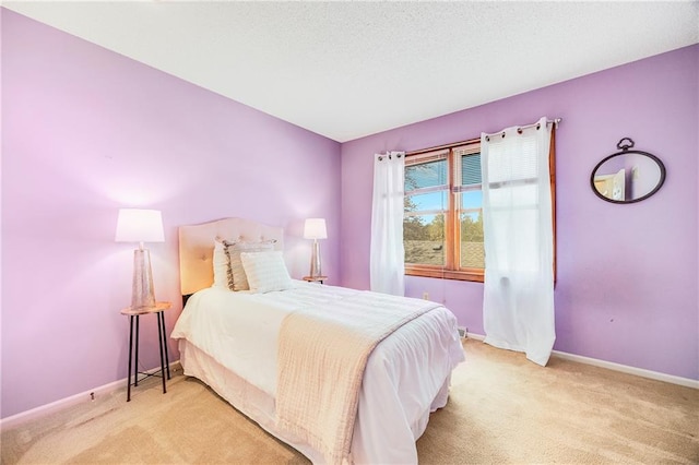 carpeted bedroom with baseboards and a textured ceiling