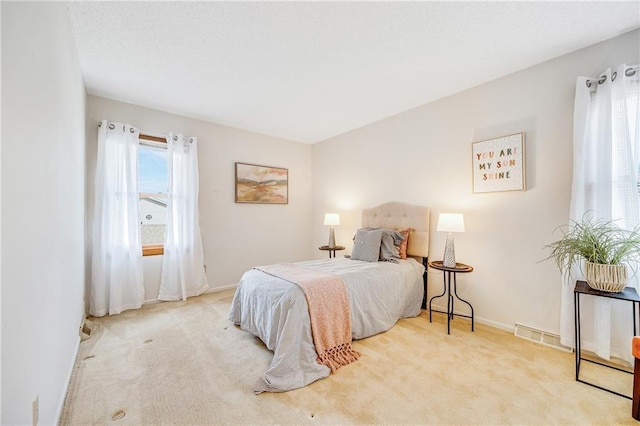 bedroom with carpet, visible vents, and baseboards