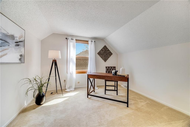 carpeted office with a textured ceiling, baseboards, and lofted ceiling