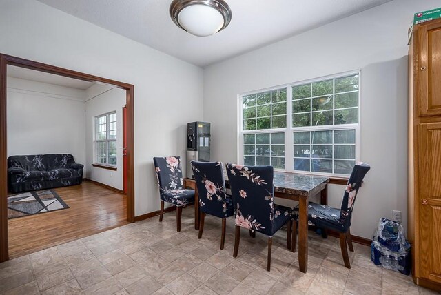 1210 Barnett Ave, Kansas City, KS 66102 - dining area with baseboards and light wood-style floors