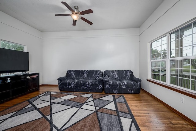 1210 Barnett Ave, Kansas City, KS 66102 - living room featuring wood finished floors, ceiling fan, and baseboards