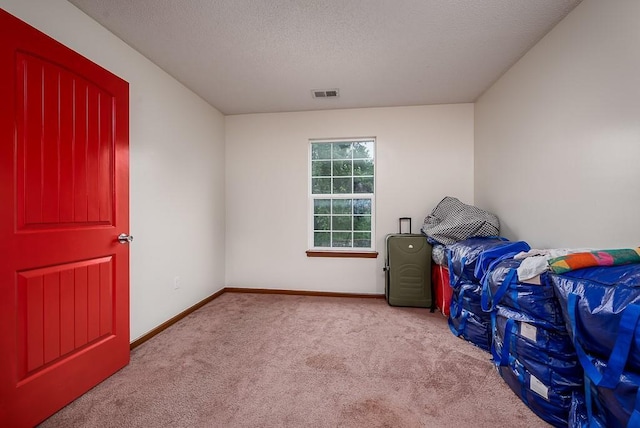 1210 Barnett Ave, Kansas City, KS 66102 - unfurnished bedroom featuring carpet, baseboards, and a textured ceiling