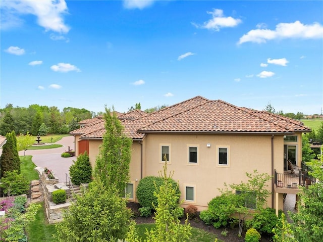 view of property exterior featuring stucco siding and a tiled roof