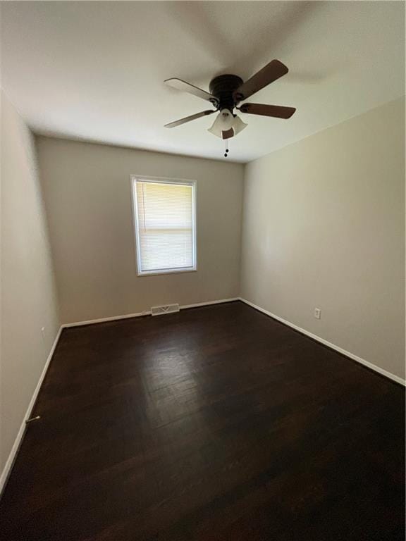 7900 W 91st St, Overland Park, KS 66212 - empty room with a ceiling fan, baseboards, and dark wood-type flooring