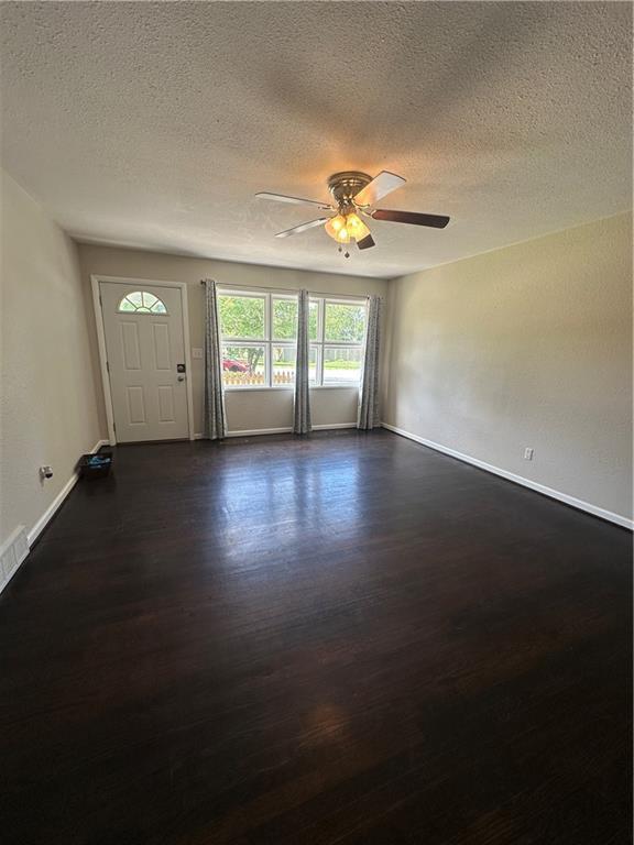 7900 W 91st St, Overland Park, KS 66212 - foyer featuring dark wood finished floors, a textured ceiling, ceiling fan, and baseboards