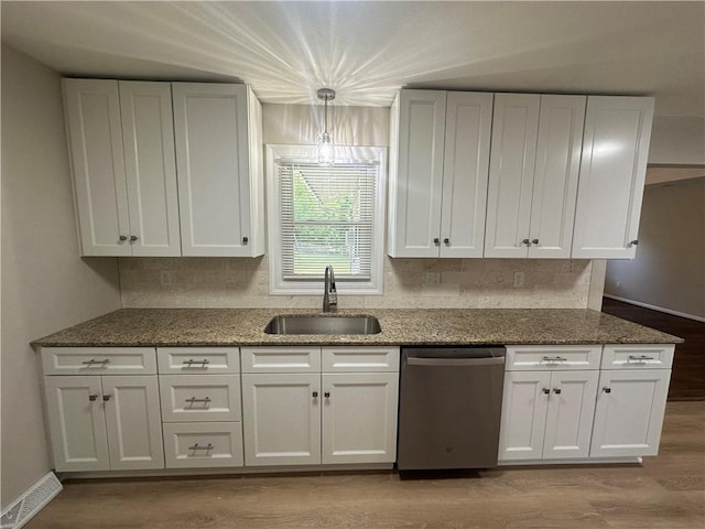 7900 W 91st St, Overland Park, KS 66212 - kitchen with dishwasher, a sink, white cabinetry, and dark stone counters