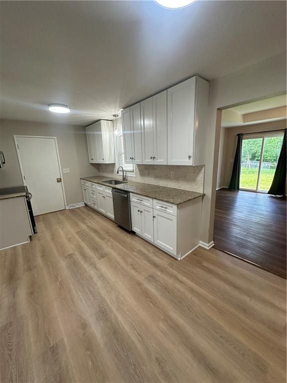 7900 W 91st St, Overland Park, KS 66212 - kitchen featuring stainless steel dishwasher, a sink, white cabinetry, and baseboards