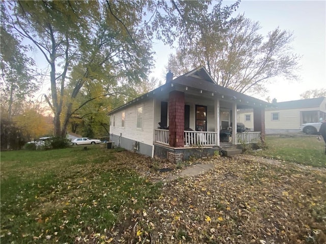 8733 E Saint John Ave, Kansas City, MO 64053 - view of front of property with a front yard and a porch