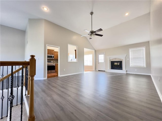 109 Deerfield Dr, Warrensburg, MO 64093 - unfurnished living room featuring a premium fireplace, ceiling fan, baseboards, and dark wood finished floors