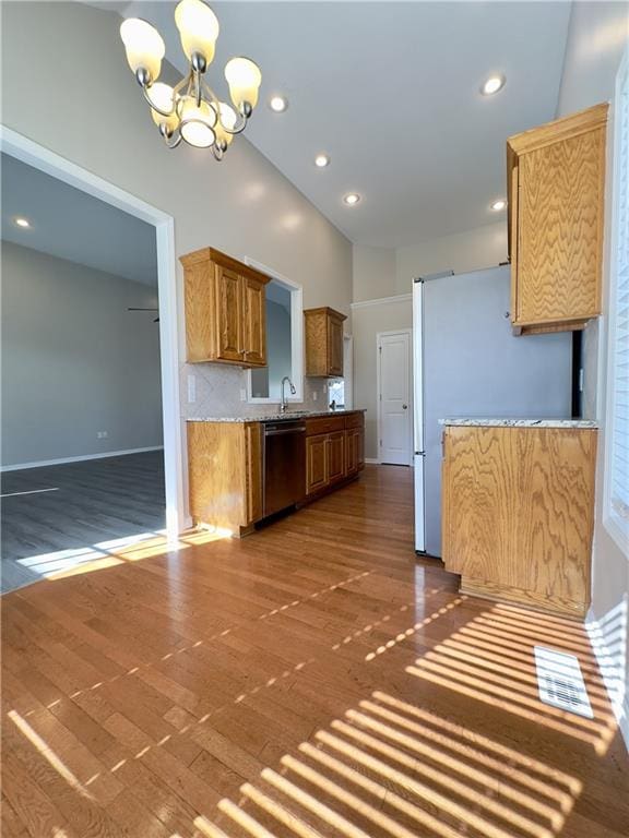 109 Deerfield Dr, Warrensburg, MO 64093 - kitchen with dark wood-type flooring, a chandelier, appliances with stainless steel finishes, a sink, and light countertops