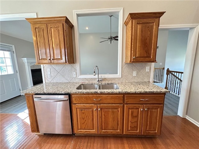 109 Deerfield Dr, Warrensburg, MO 64093 - kitchen with stainless steel dishwasher, light stone countertops, a ceiling fan, hardwood / wood-style floors, and a sink