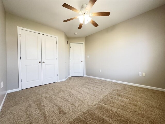 109 Deerfield Dr, Warrensburg, MO 64093 - unfurnished bedroom featuring a closet, carpet, baseboards, and ceiling fan