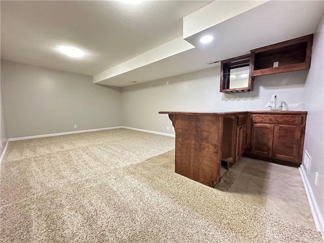 109 Deerfield Dr, Warrensburg, MO 64093 - bar with a sink, light colored carpet, baseboards, and wet bar