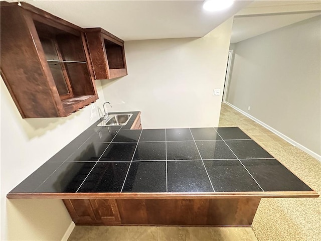 109 Deerfield Dr, Warrensburg, MO 64093 - kitchen with a peninsula, tile countertops, baseboards, and a sink