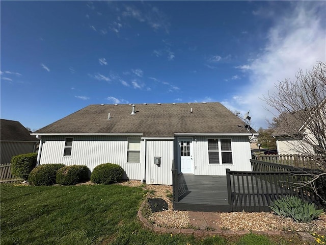109 Deerfield Dr, Warrensburg, MO 64093 - back of house with a yard, a wooden deck, fence, and a shingled roof