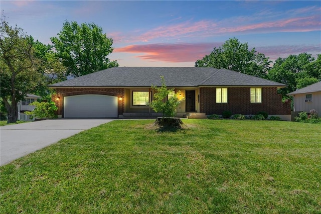ranch-style house with concrete driveway, an attached garage, brick siding, and a lawn